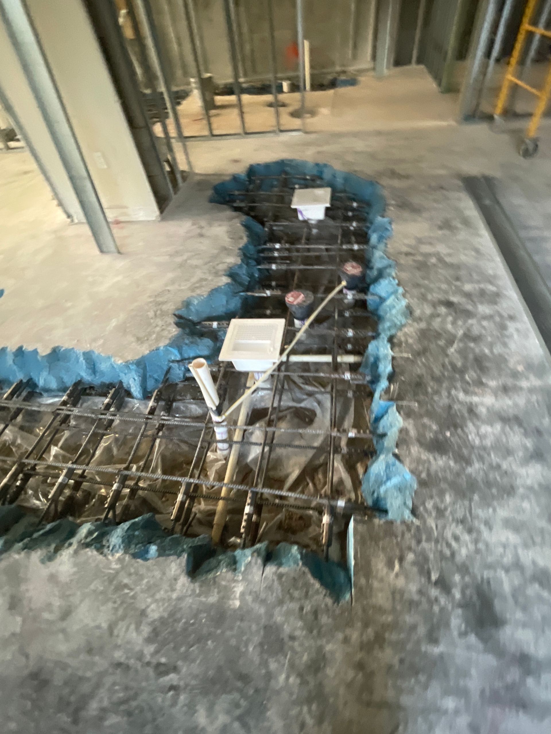 A hole in the floor of a building under construction.