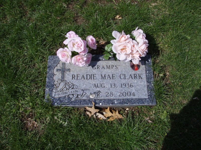 Gravestone with pink flowers; 