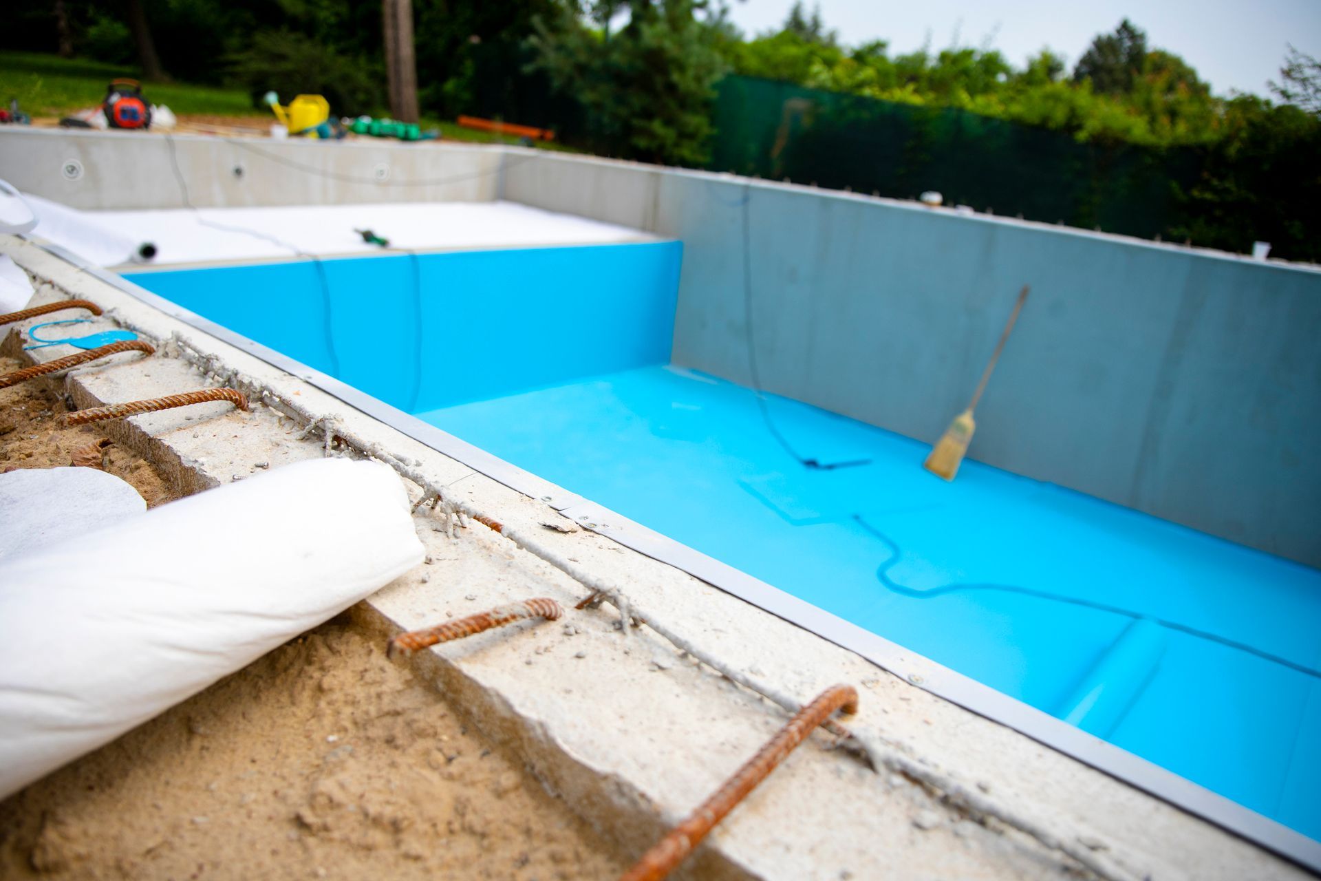 Commercial pool contractor working on concrete foundation of new commercial pool build