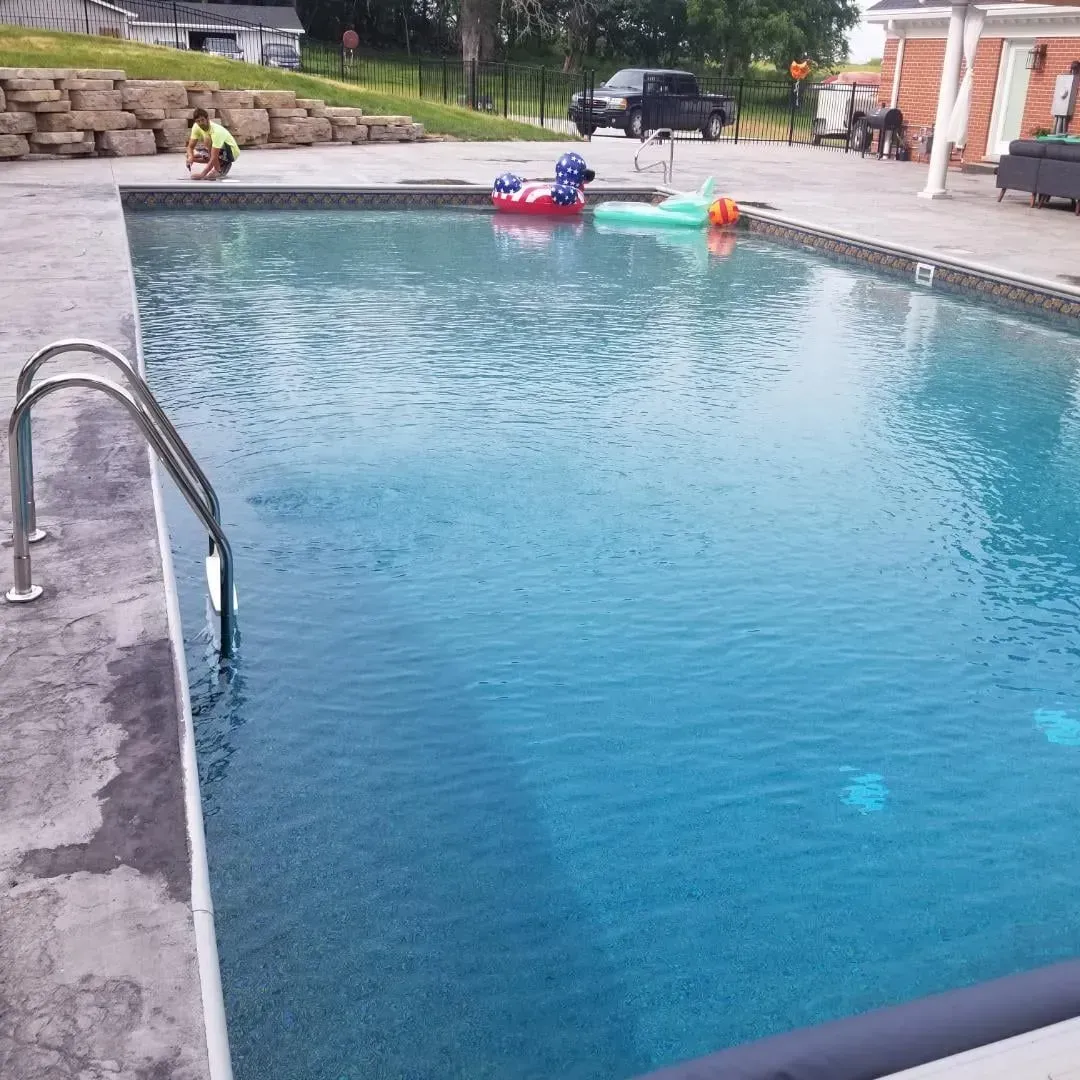 A large swimming pool with a duck float in it.