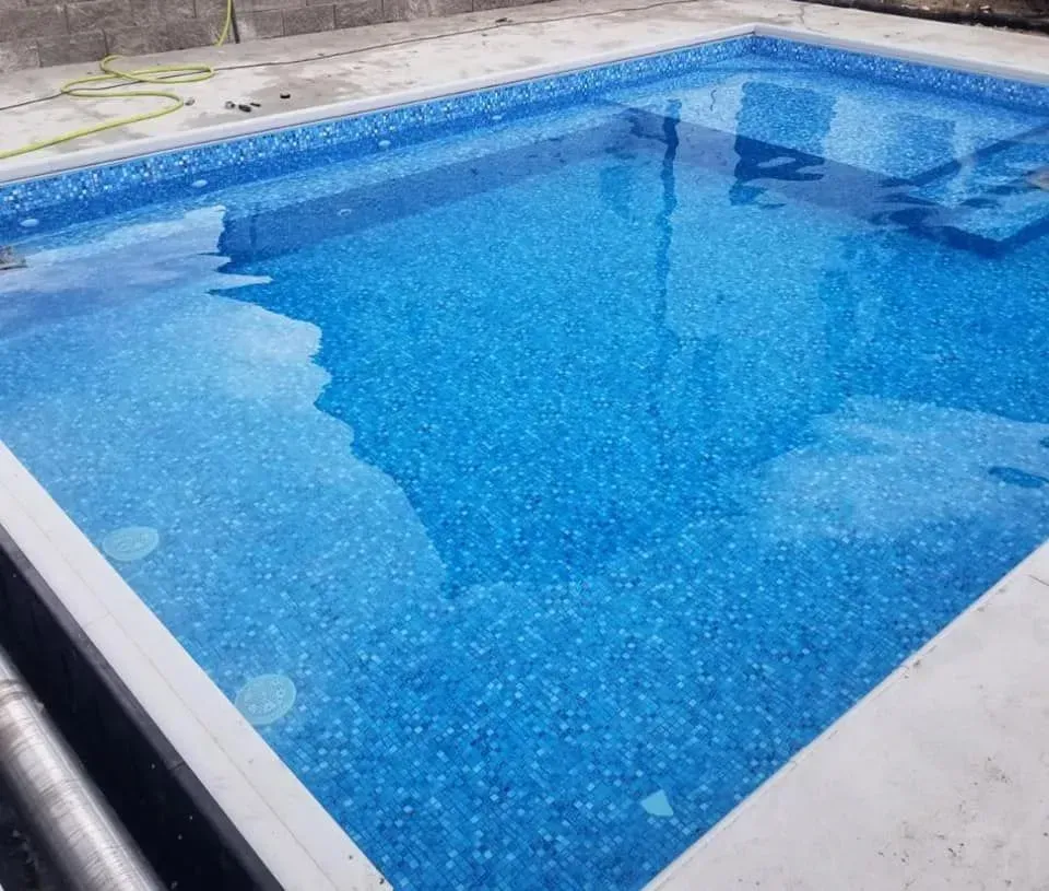 A large swimming pool filled with blue water