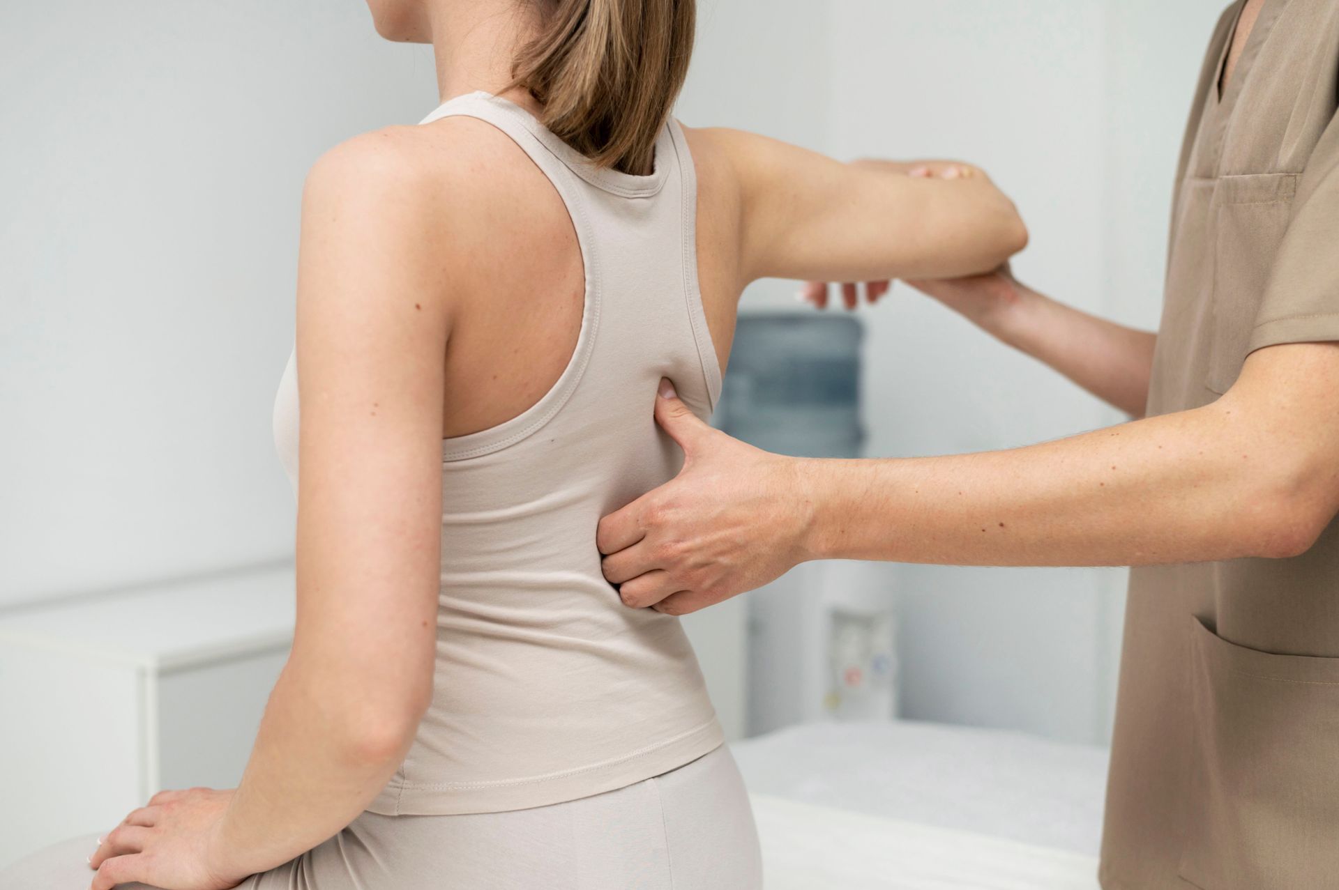 A woman is getting her back examined by a doctor.