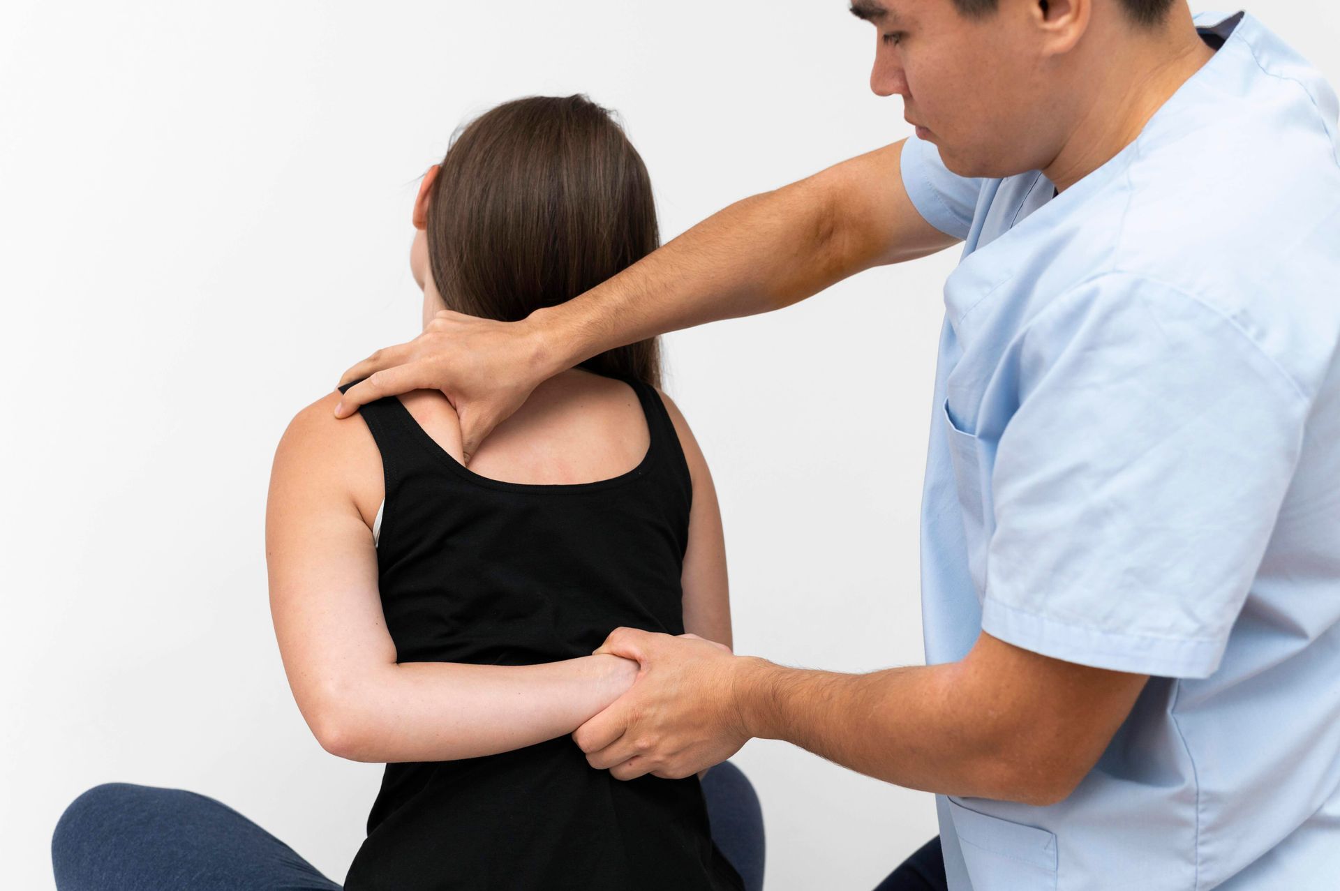 A man is giving a woman a massage on her back.