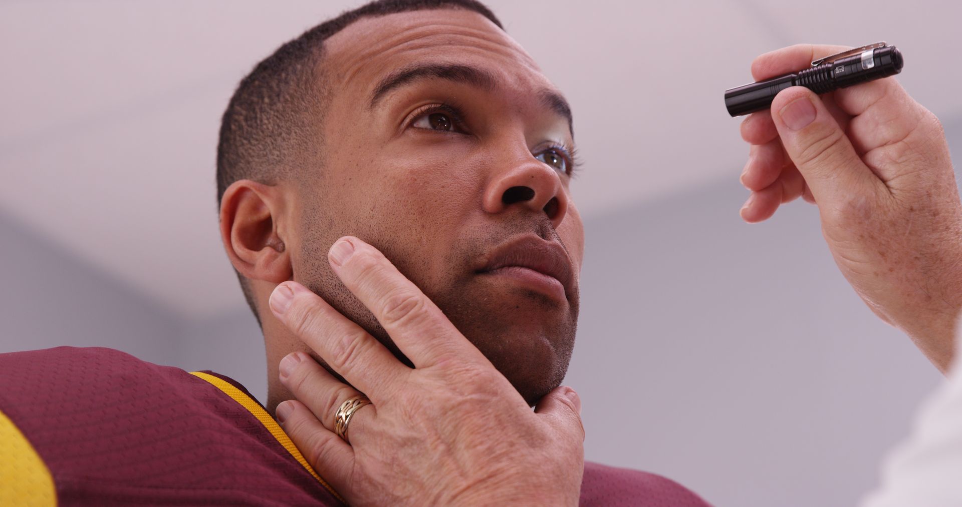 A man is getting his eyes examined by a doctor.