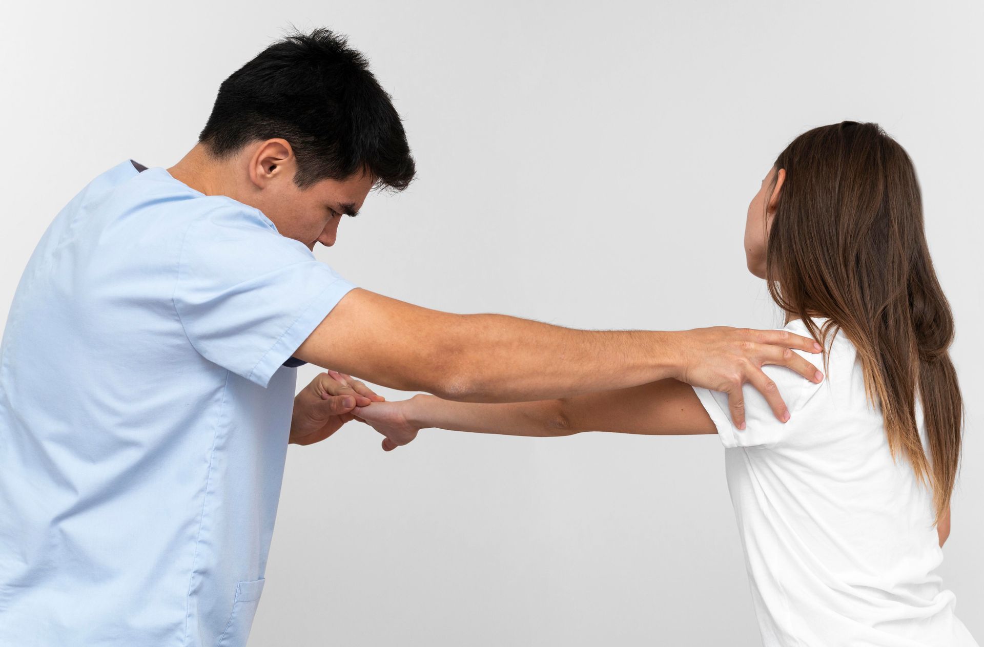 A man and a woman are standing next to each other and holding hands.