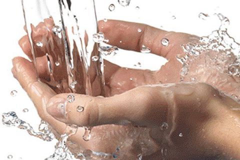 Hands in running water - Pump Installation in Windham, NH