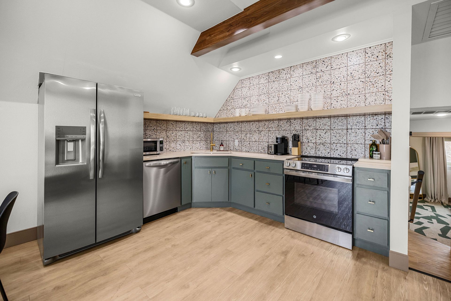 Fully stocked kitchen complete with refrigerator, oven, and microwave.