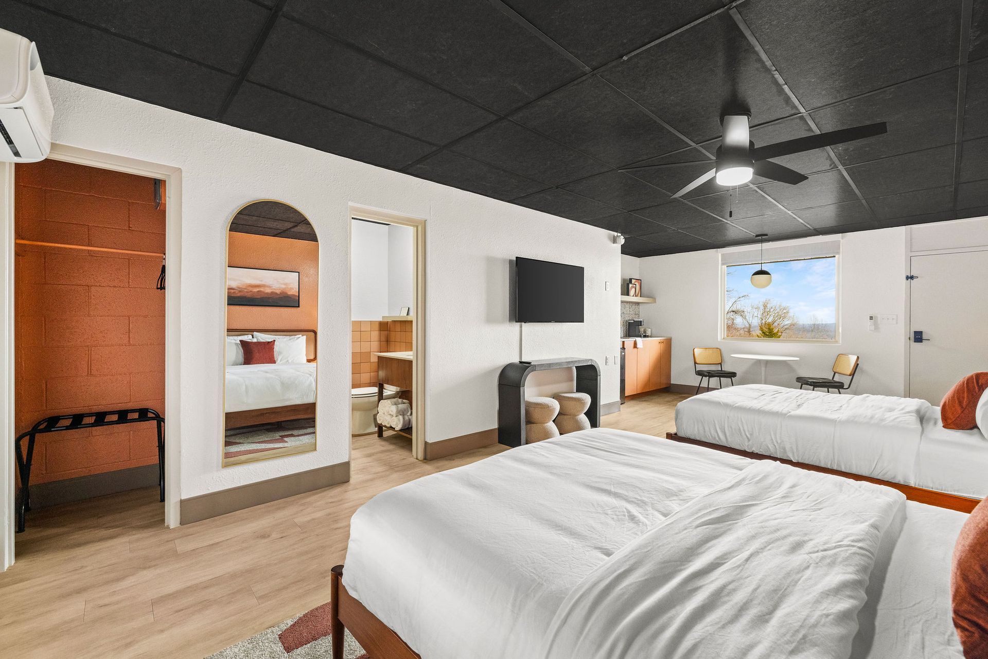 A flat screen tv is mounted on a wall above a console table.