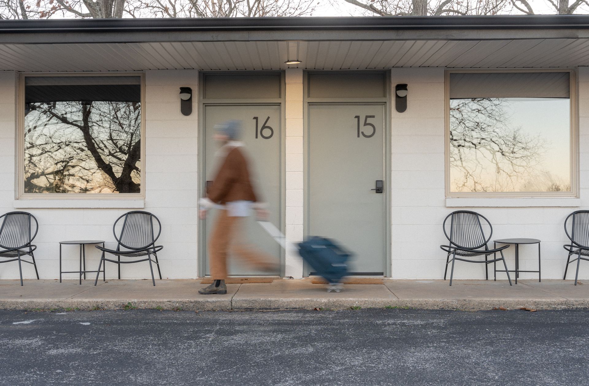Two people are fishing in a boat on a lake.