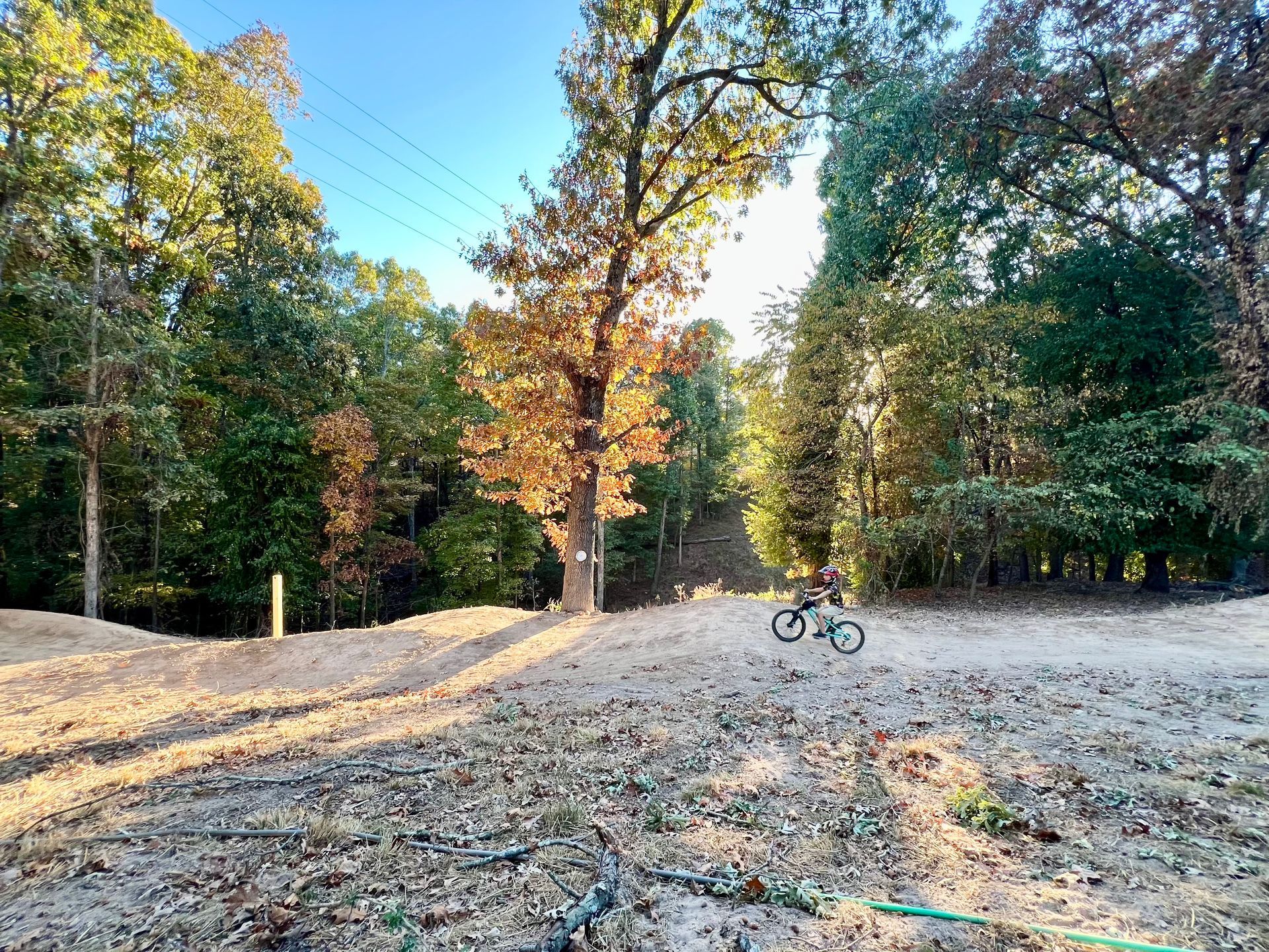 A group of people are sitting around a campfire at night.