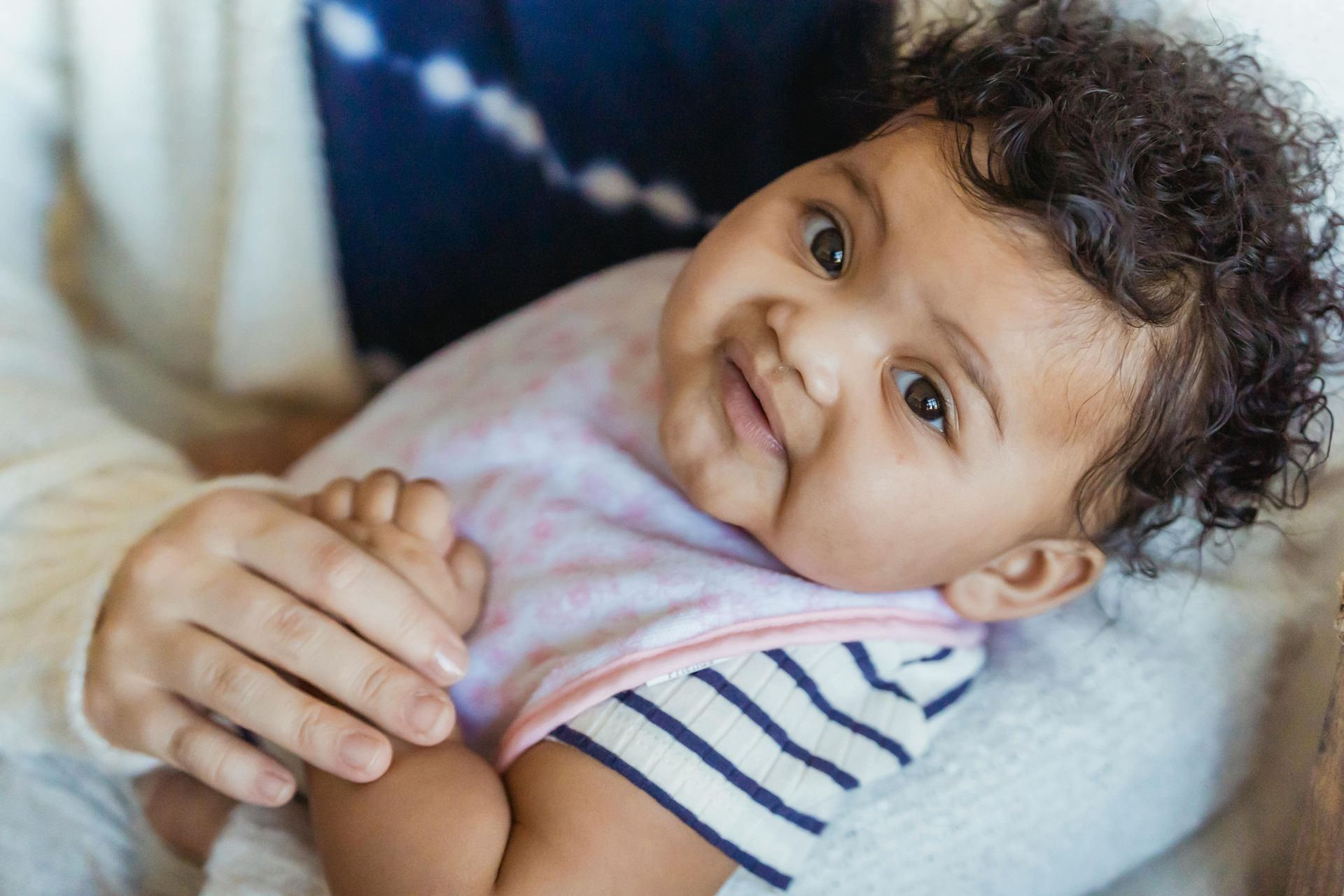 Smiling baby being cared for in a safe and nurturing in-home setting