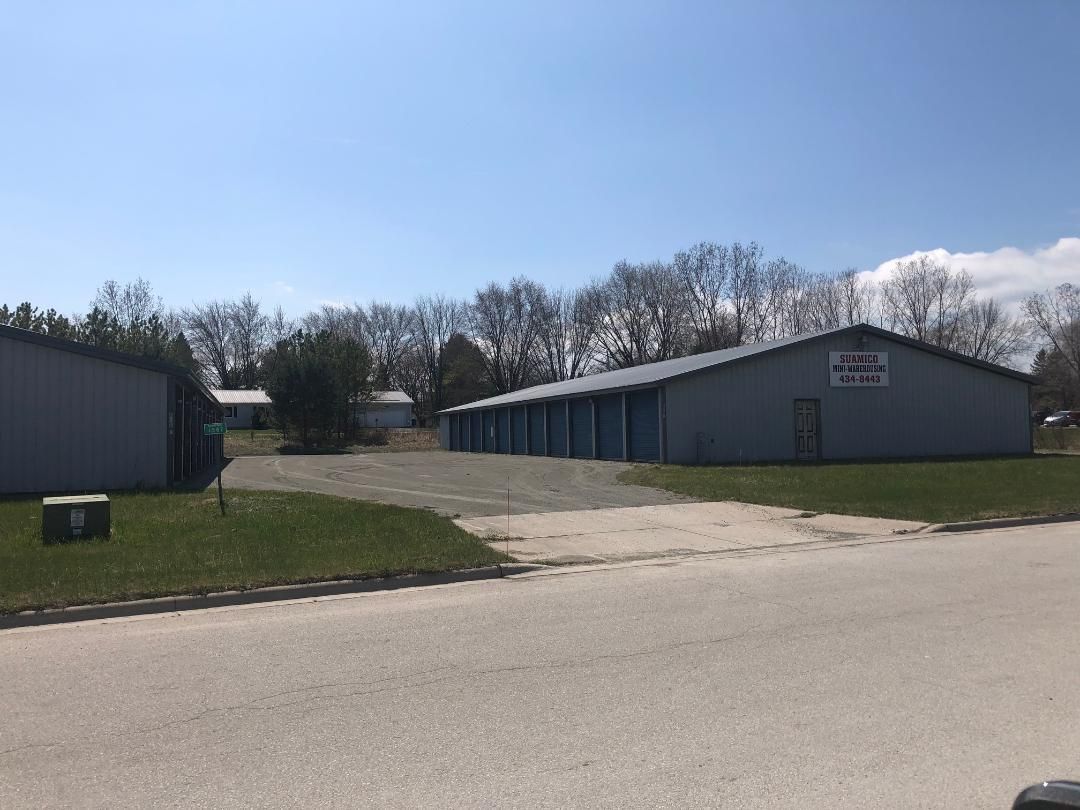 A couple of buildings sitting next to each other on the side of a road.