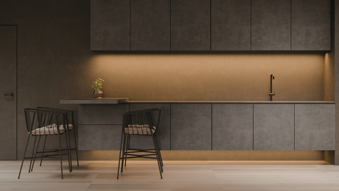 A modern, dark-toned kitchen with concrete-style cabinets, a small bar area with two wire chairs, and warm under-cabinet