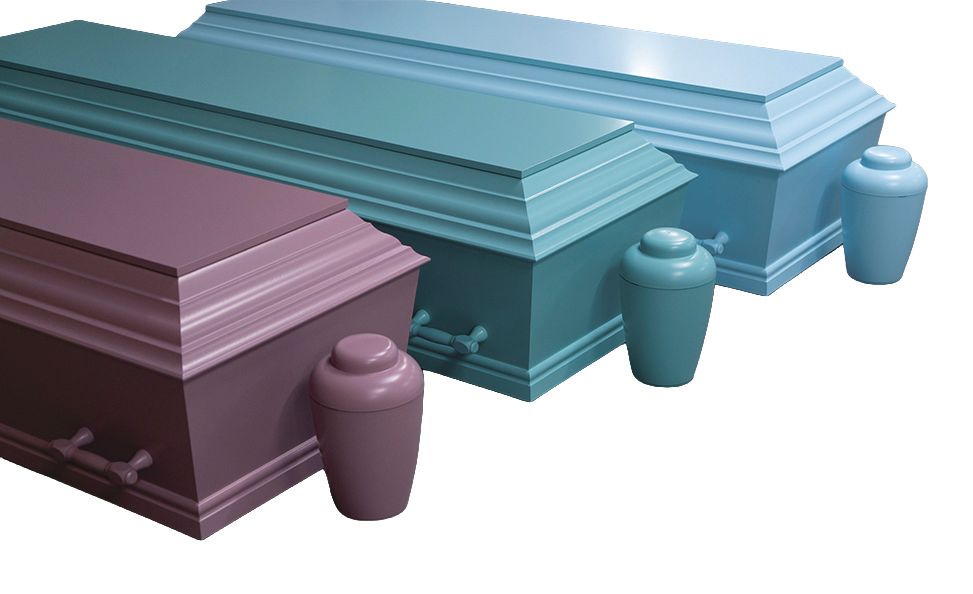 Black coffin with floral wreath on top.