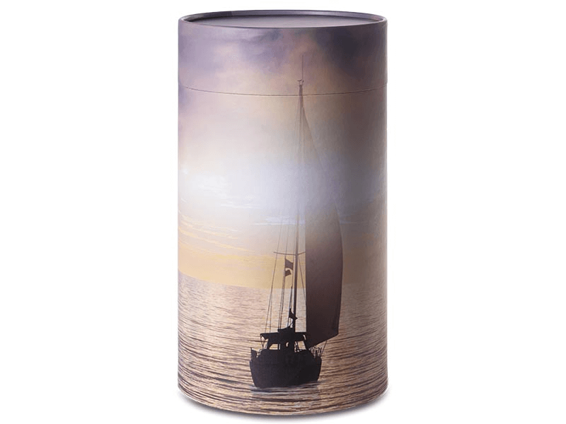 Urn with sailboat silhouette on water at sunset.