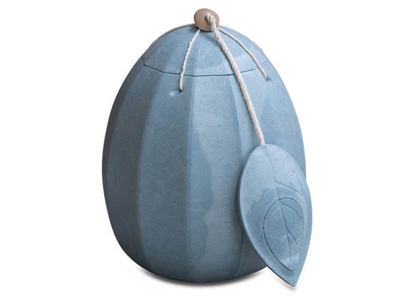 Blue egg-shaped urn with leaf-shaped tag, tied with string, on a white background.