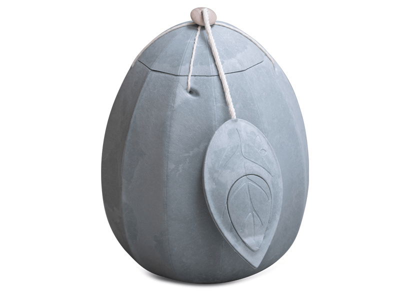 Gray urn in the shape of an egg with a leaf-shaped embellishment, and a string with a bead at the top.