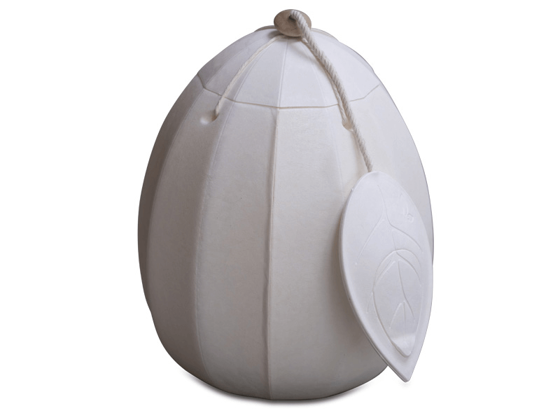 White egg-shaped urn with vertical ridges, a looped top, and a leaf-shaped tag hanging on the side.