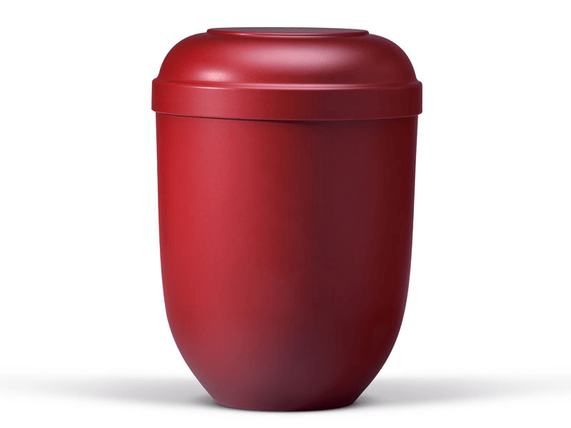 Red urn, cylindrical with a rounded top, for storing cremated remains.