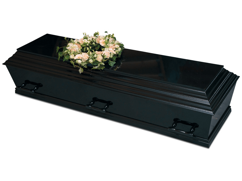 Black coffin with floral wreath on top.