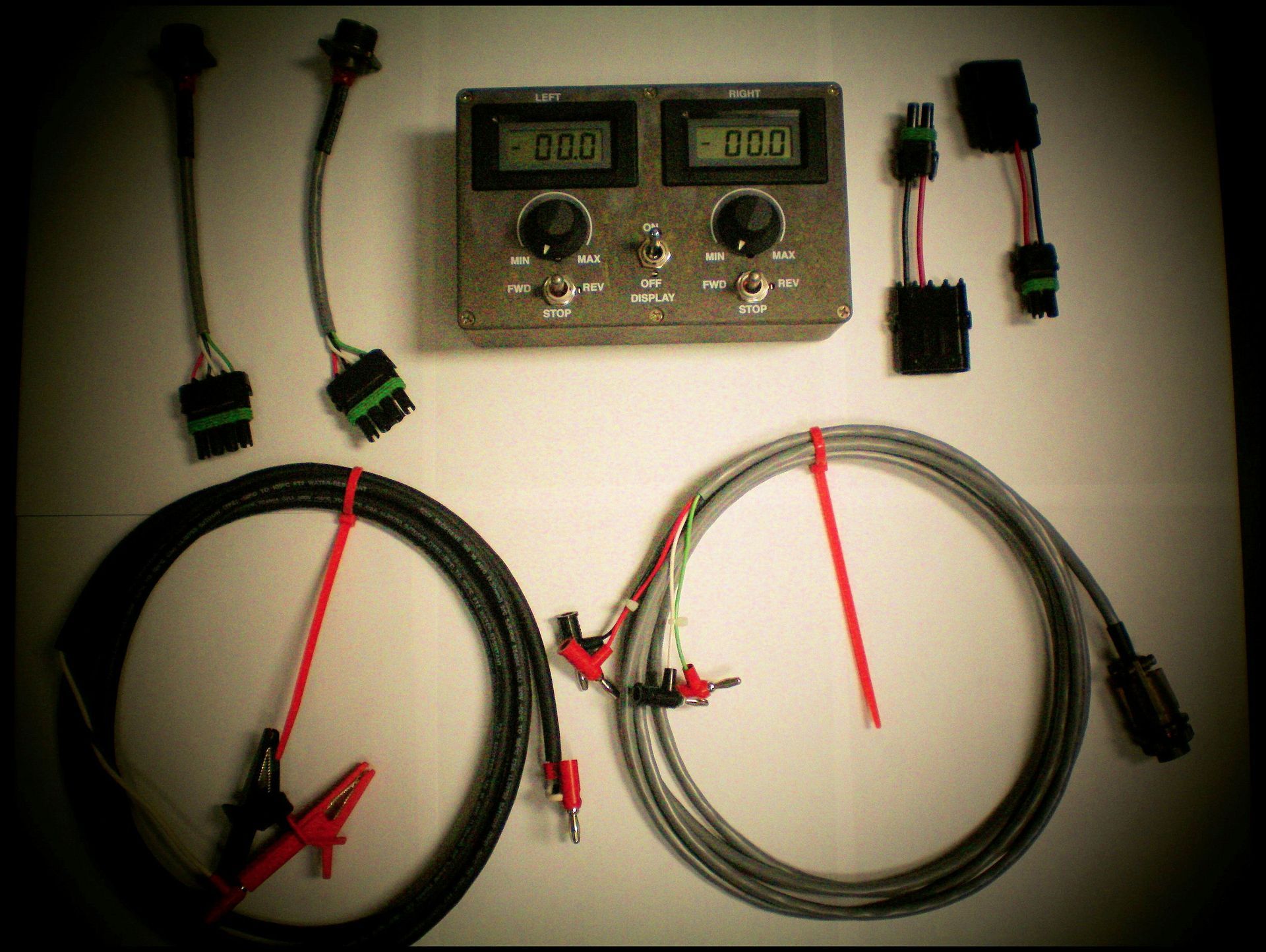 A row of red pipes and valves in a factory.