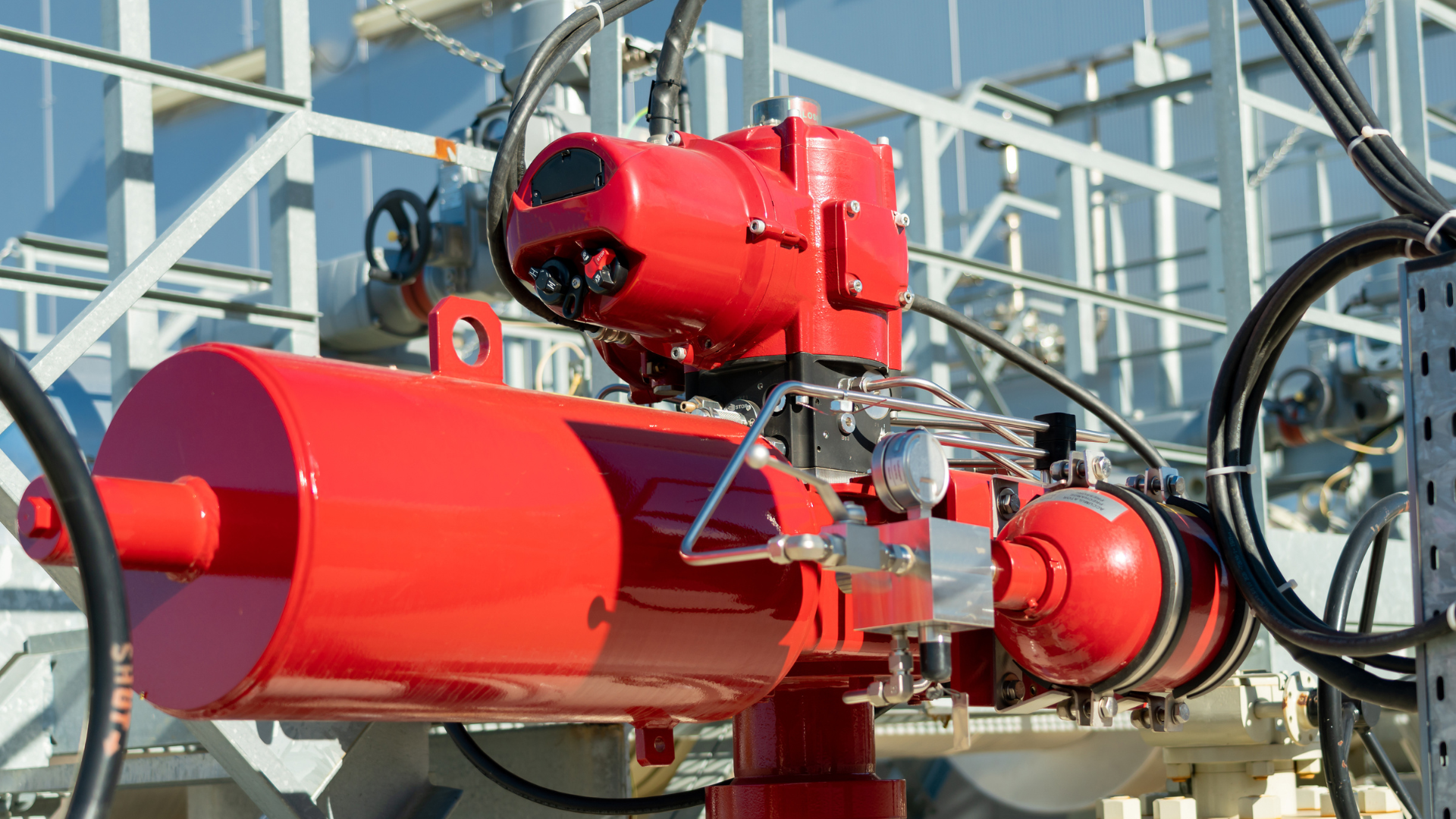 A red machine is sitting on top of a metal structure.