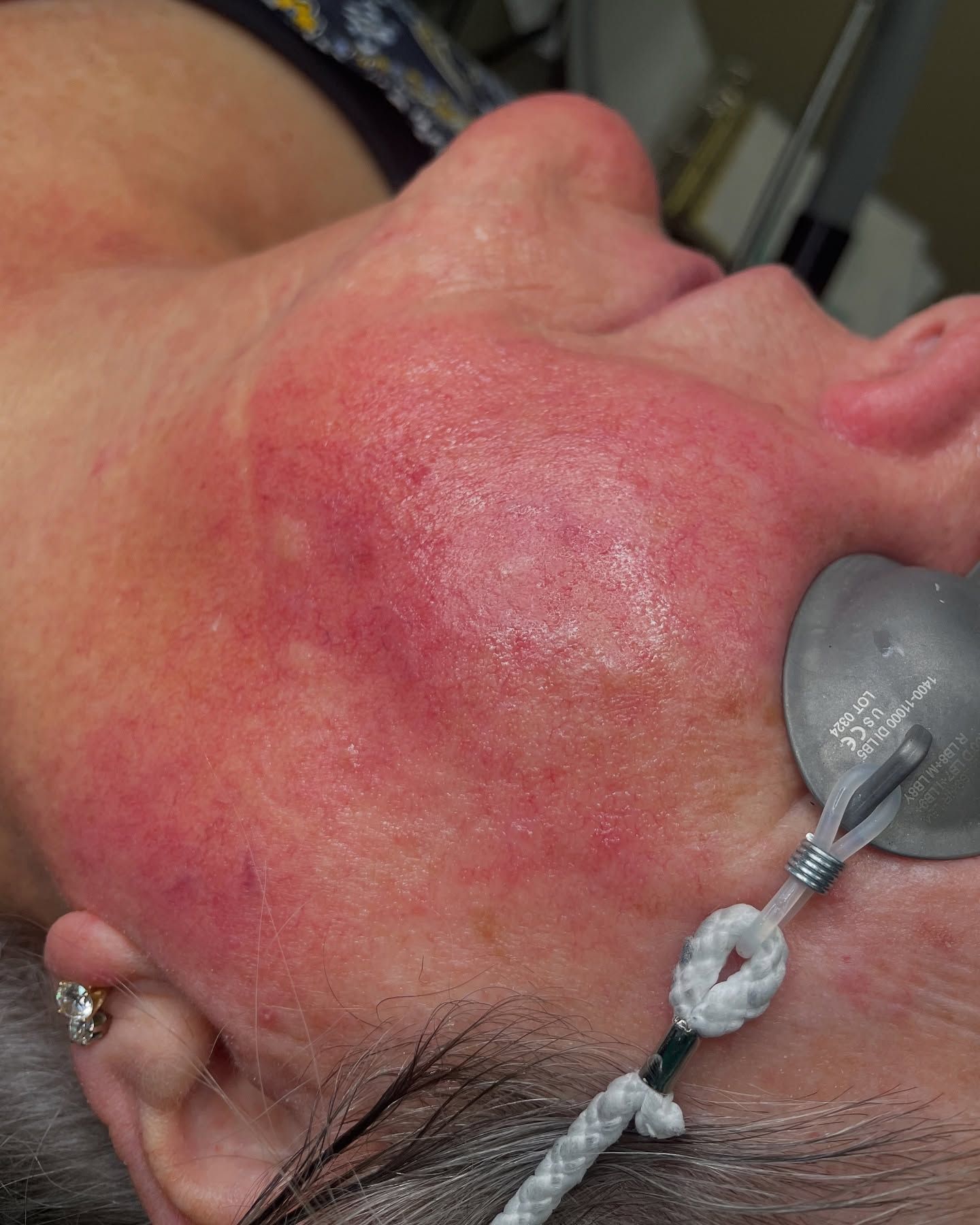 A large house with a lot of windows and a garage on a rainy day.