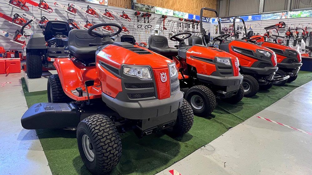 A Row of Lawn Mowers Are Lined up In a Showroom — CBS Chainsaw & Brushcutter Specialists - HUSQVARNA in Wauchope, NSW