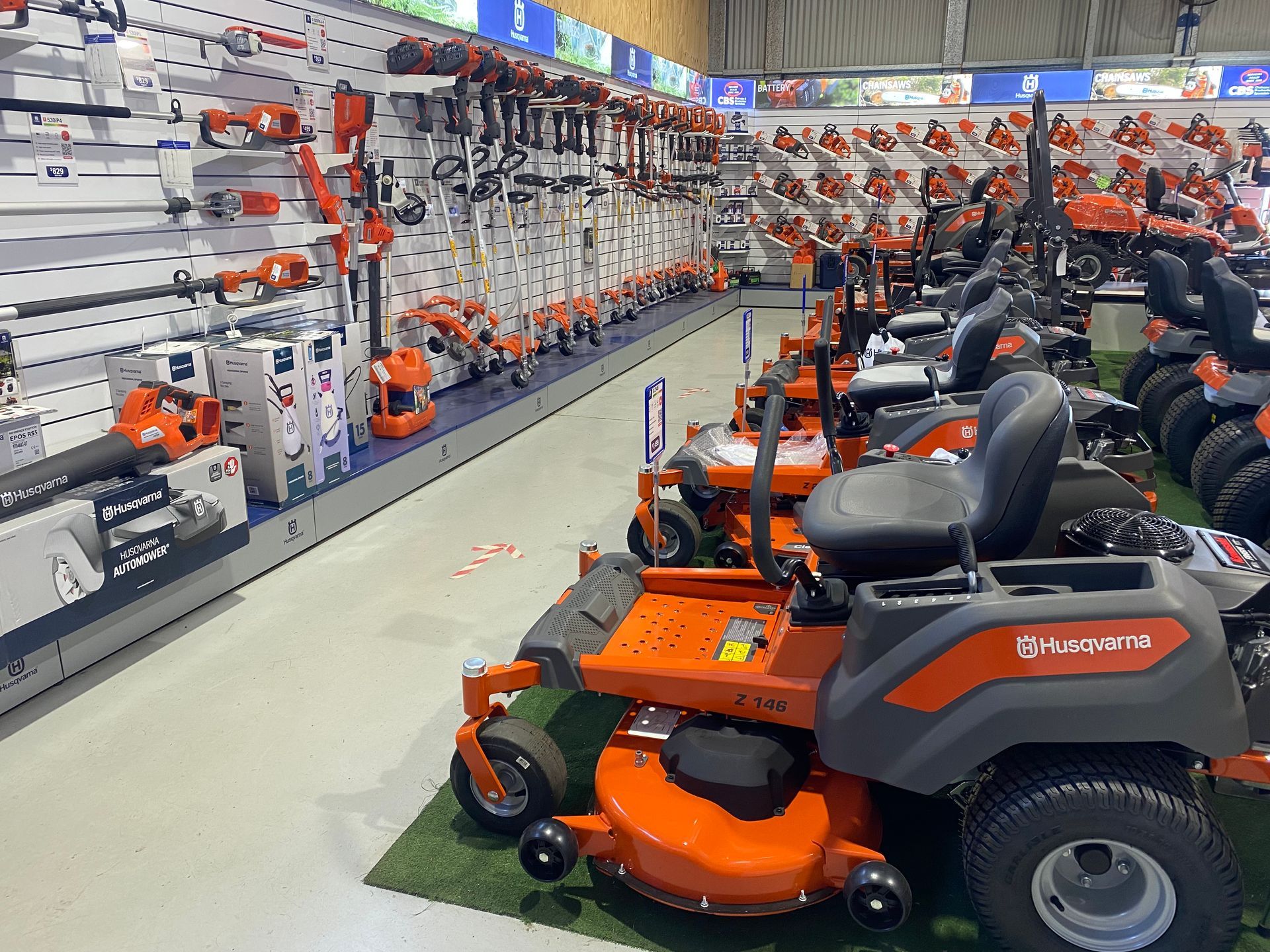 A Man Is Holding a Pole Saw in A Forest — CBS Chainsaw & Brushcutter Specialists - HUSQVARNA in Wauchope, NSW