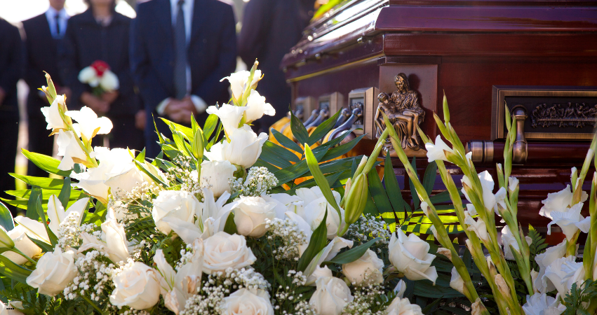 Funeral flowers during a eulogy that was written meaningfully 