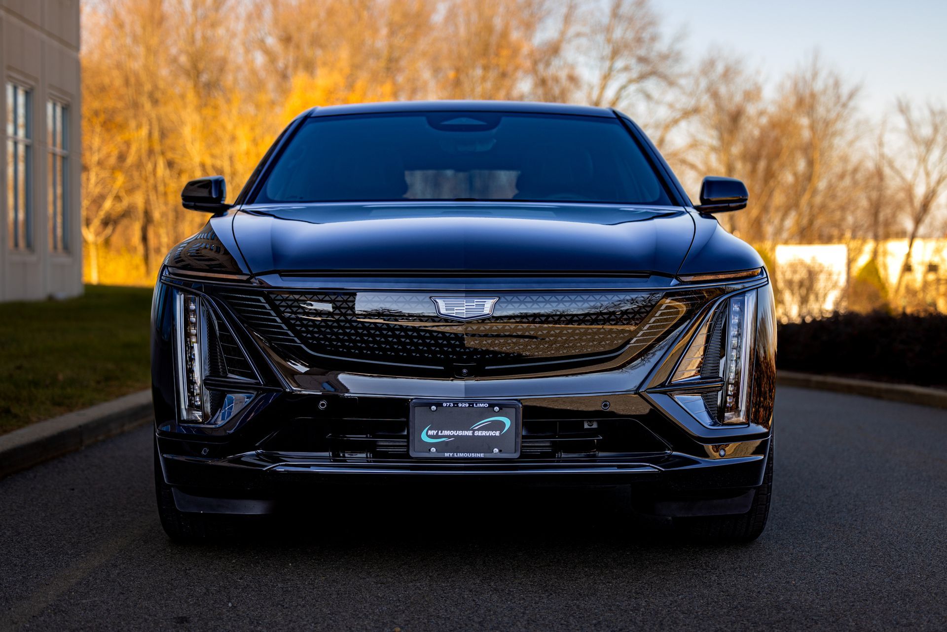A black electric car is parked on the side of the road in front of a building in East Hanover NJ.