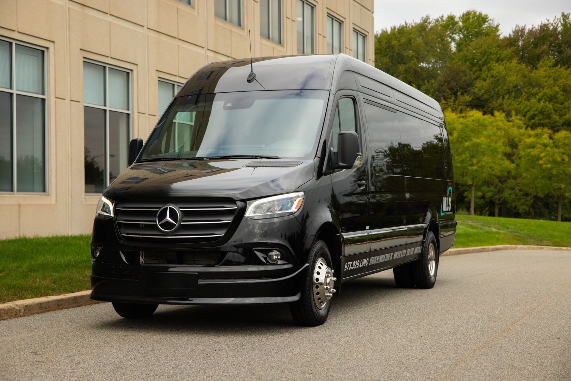 A white van is parked in front of a building.