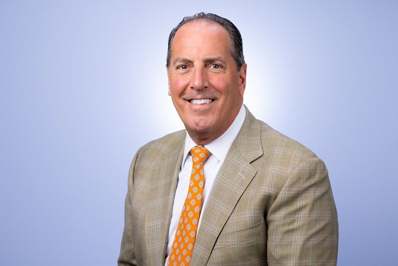 Pat Fragale of My Limo in a suit and blue shirt is smiling for the camera.