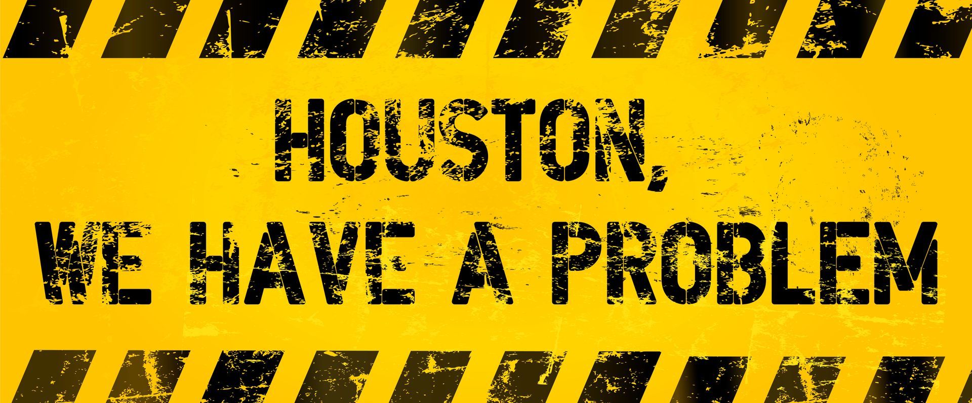 Yellow caution sign with black stripes reading “HOUSTON, WE HAVE A PROBLEM”