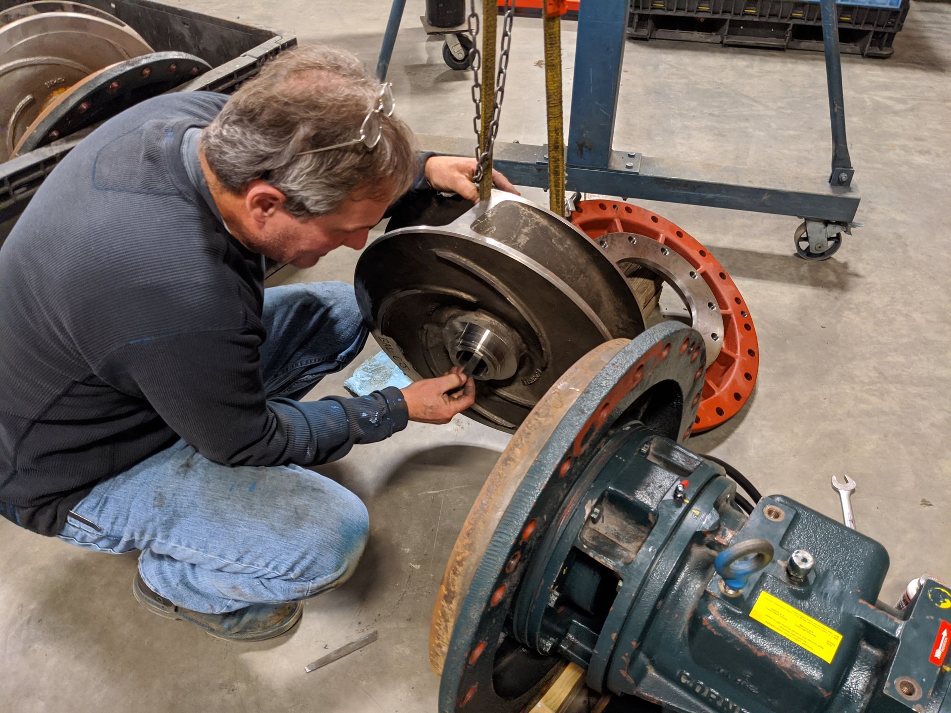 A man is working on a machine in a factory.