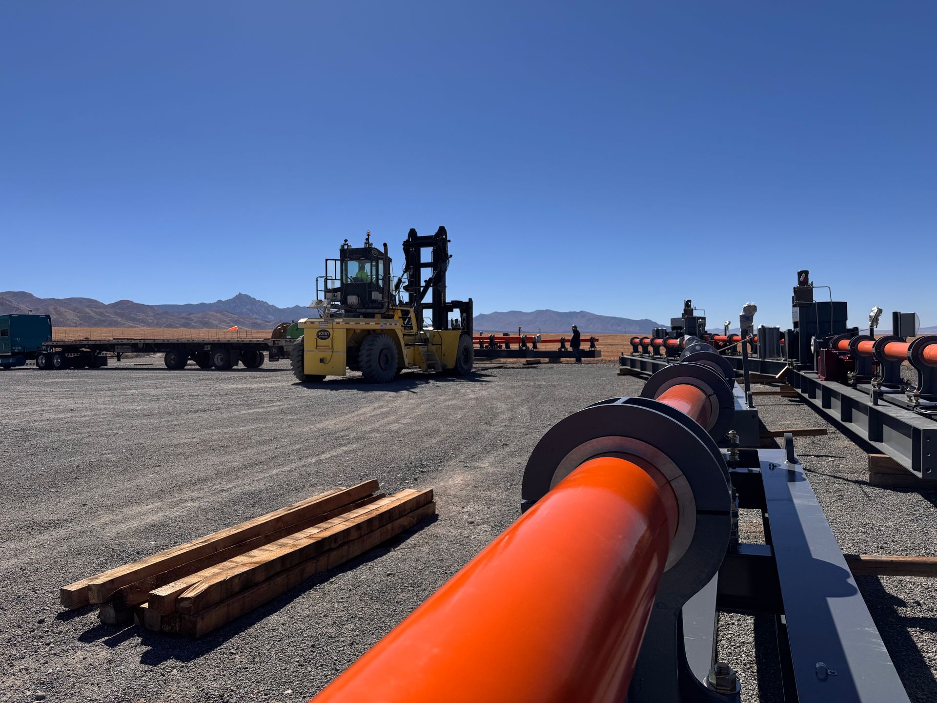 A blue and yellow machine with a hose attached to it