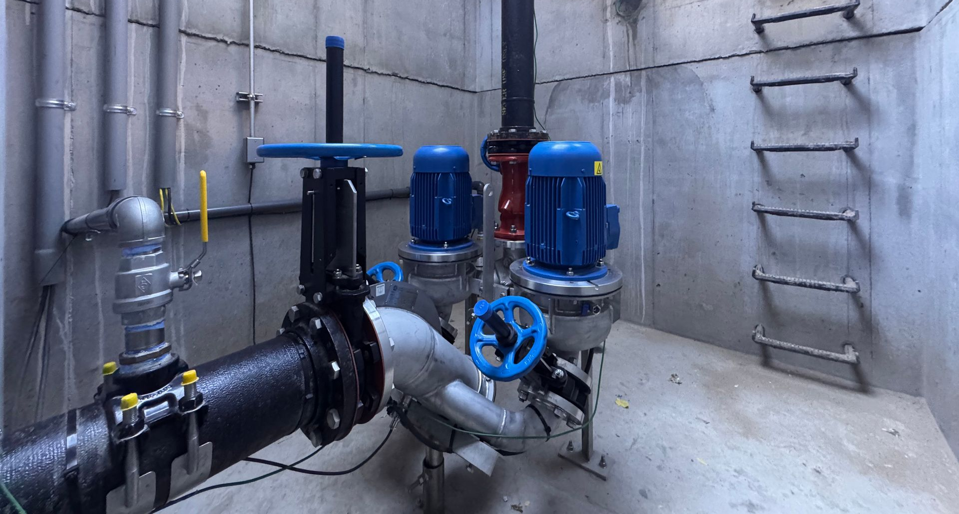 A row of pumps and pipes in a factory.