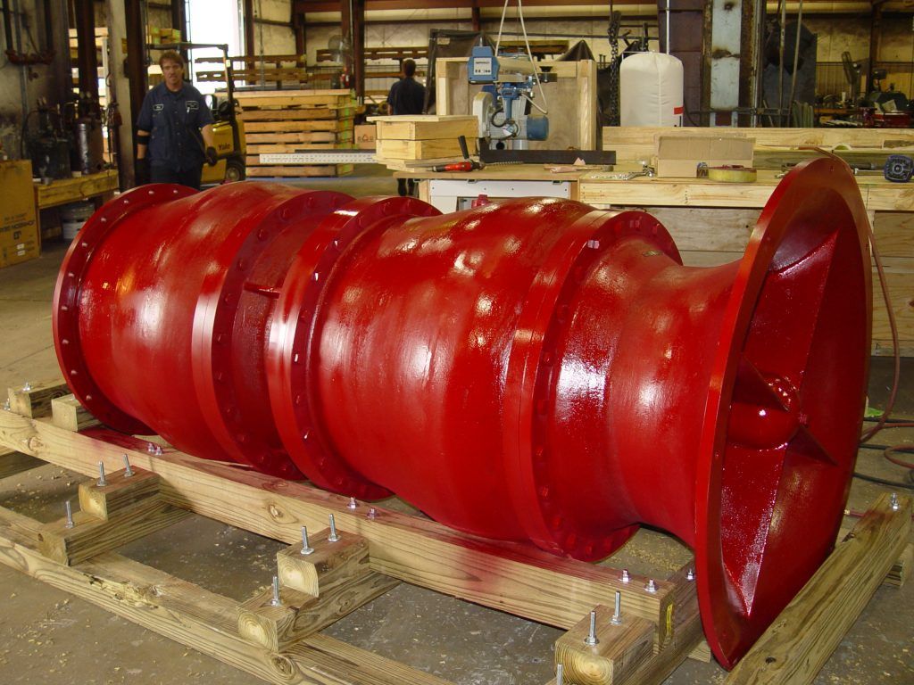 A large red object is sitting on a wooden pallet