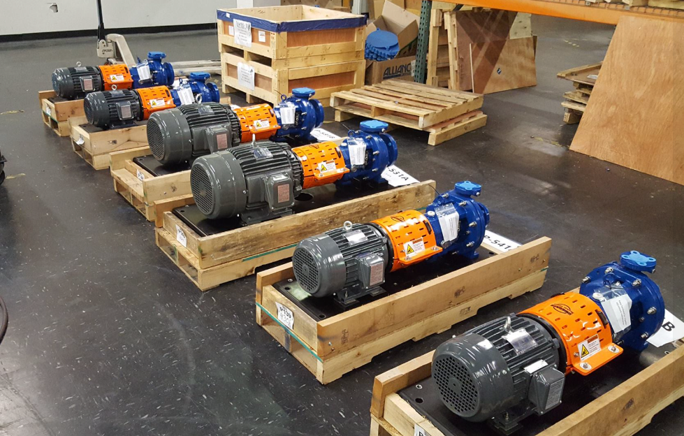 A row of pumps and pipes in a factory.