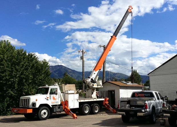 A truck with a crane attached to the back of it