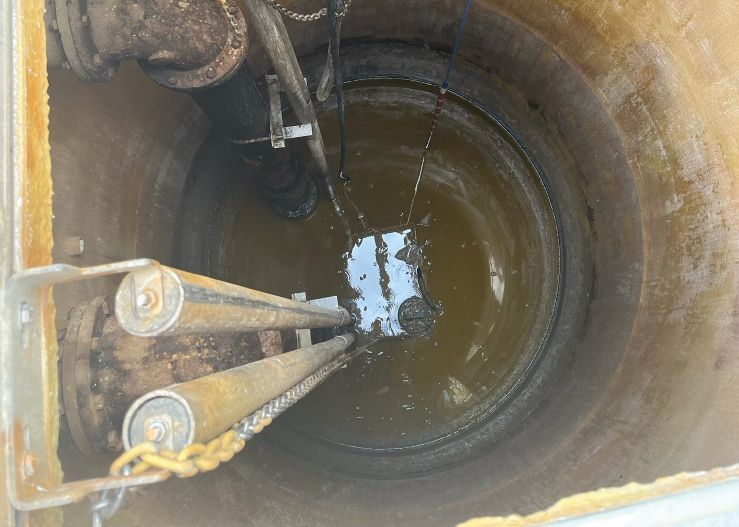 A manhole cover with water coming out of it.