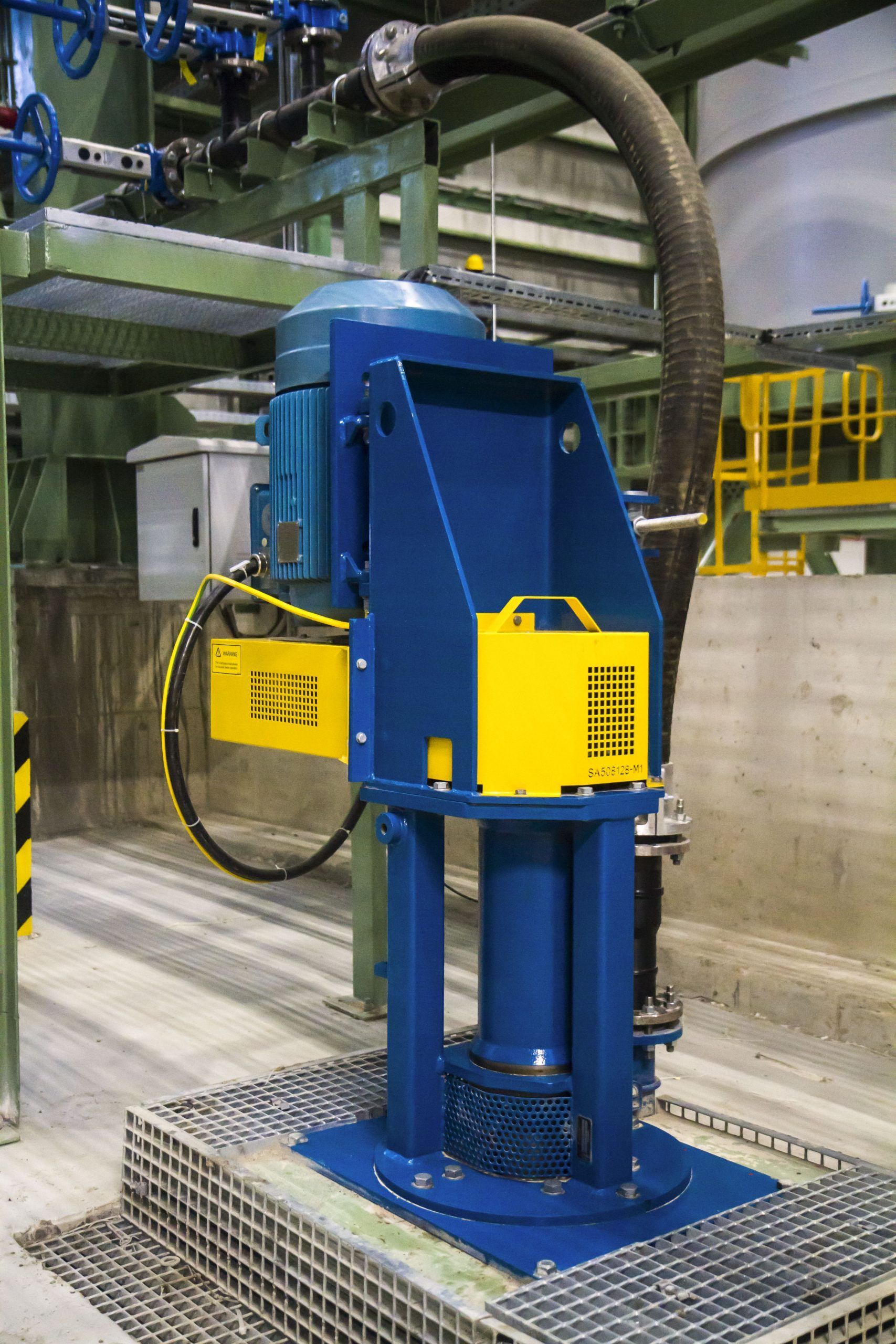 A blue and yellow machine with a hose attached to it