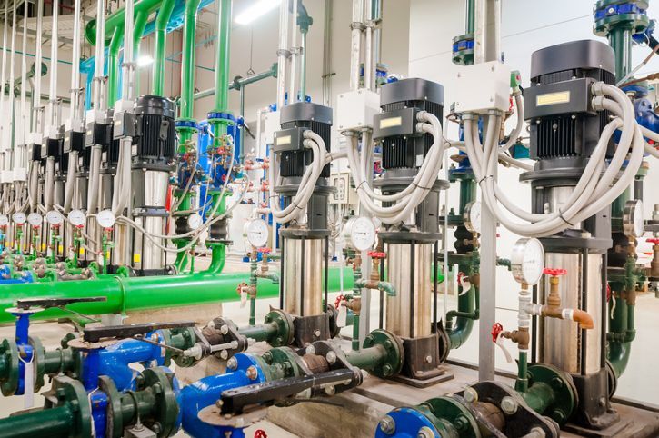 There are a lot of pumps and pipes in this room.