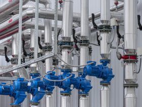 A row of pipes and valves in a factory.