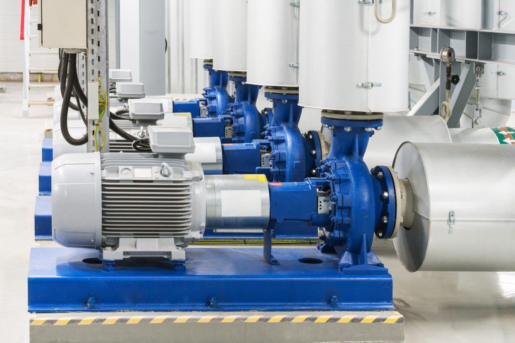 A row of water pumps are lined up in a factory.