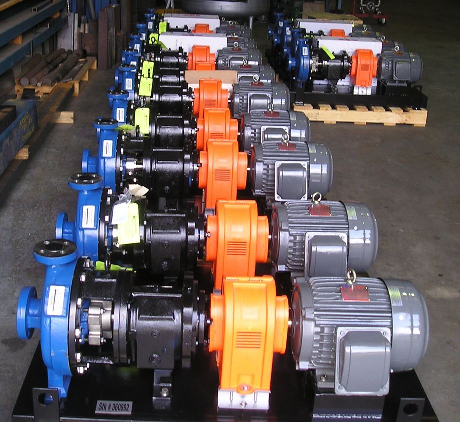 A bunch of different colored pumps are lined up in a row