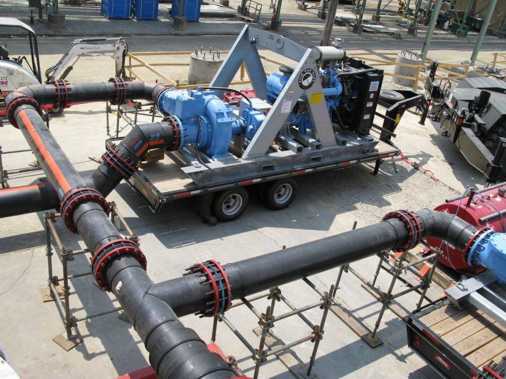 A trailer with a bunch of pipes attached to it