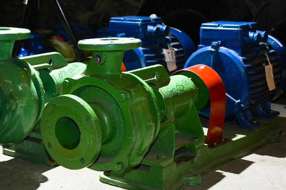 A row of green pumps are lined up next to each other