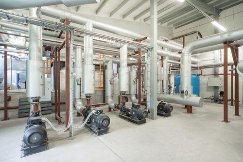 There are a lot of pipes and pumps in this room.