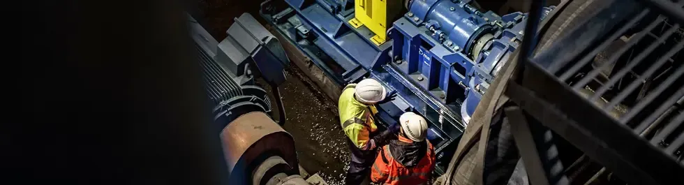 A row of pumps and pipes in a factory.